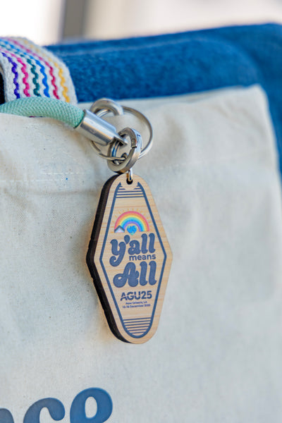 The AGU25 keychain is shown with a cotton tote bag