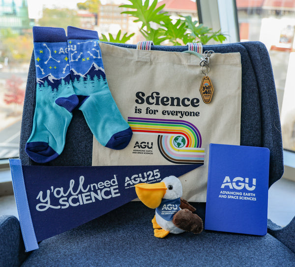 A collection of 2025 AGU merchandise, including AGU25 mascot, Night Sky Socks, tote bag, AGU25 keychain, AGU notebook and AGU25 pennant