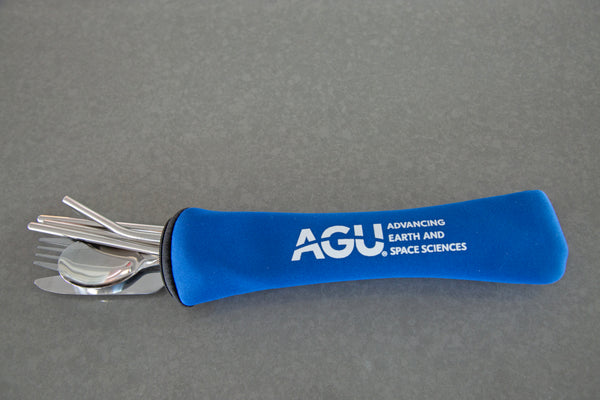 A set of stainless steel flatware is displayed sticking out of a blue pouch with the AGU logo printed in white.