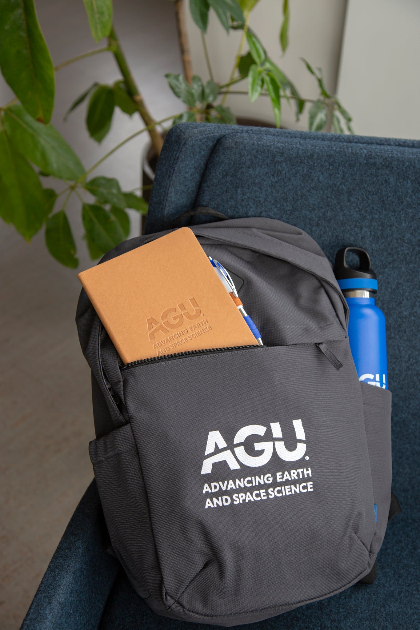 AGU backpack, packed with an AGU notebook and AGU waterbottle