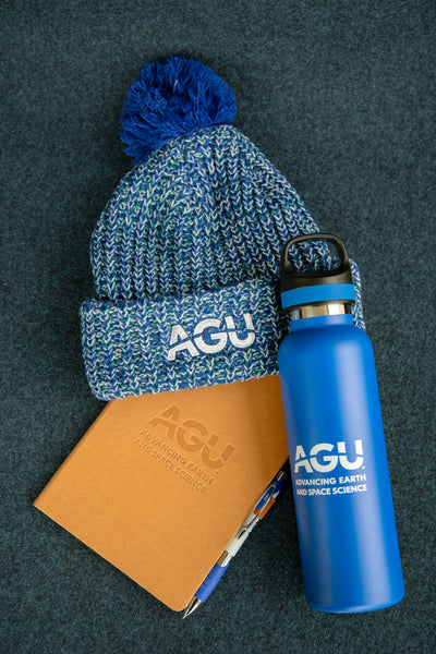 The AGU water bottle displayed with the AGU hat and AGU notebook